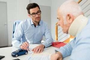 a man talking with an injured elderly man