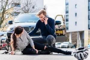 a woman laying in the street after being hit