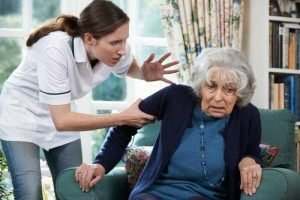 a woman yelling at an elderly patient