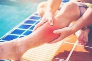 man holding his injured leg