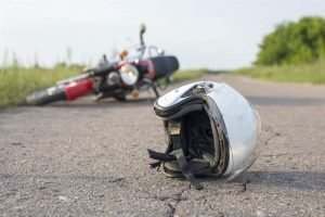 a helmet and motorcycle on the ground