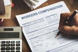 person filling out worker's compensation form
