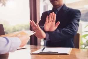 someone motioning no to paperwork