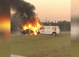 crashed van and car on fire