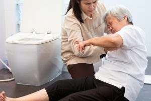 elderly Asian lady slipping and falling in the bathroom