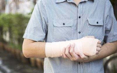 man-holding-his-broken-wrist-in-a-cast