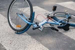 Blue,Child's,Bicycle,Lying,On,A,Pedestrian,Crossing,After,A