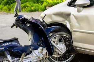 Blue motorcycle crashed into vehicle tire