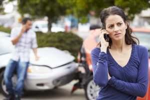 female driver making a phone call after an accident