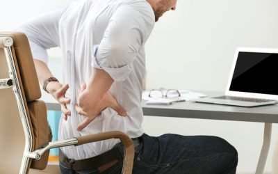 man with a backache in an office chair