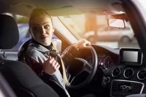 woman backing up her car