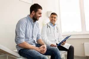 doctor talking to his patient and smiling