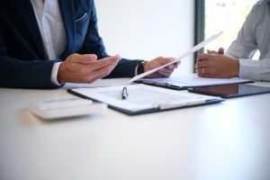 insurance agent and client discussing paperwork