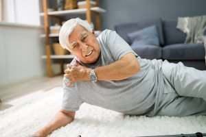 senior man on the floor with a hurt shoulder