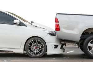 white car rear-ending a truck